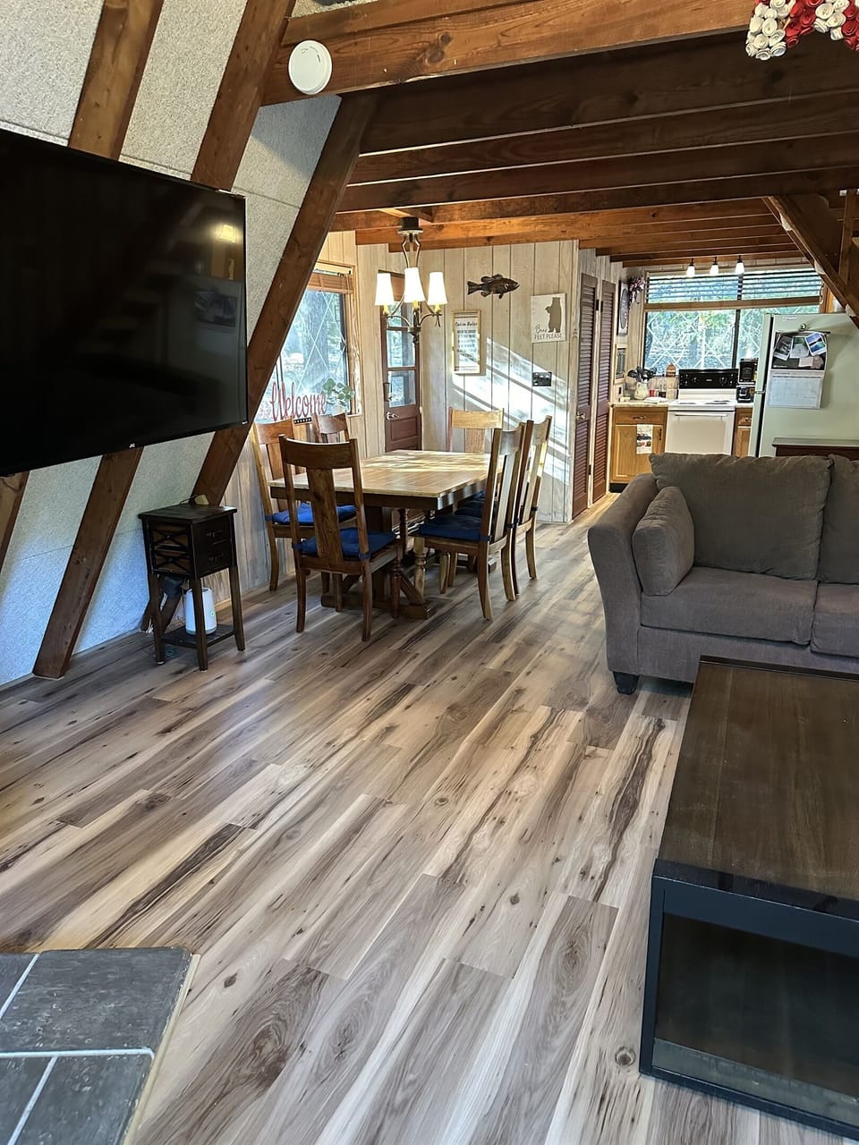 New flooring and whitewashed paneling in the kitchen area