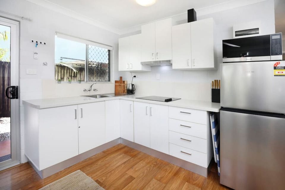 Modern Kitchen: Sleek design with top appliances and a view—perfect for culinary adventures!
