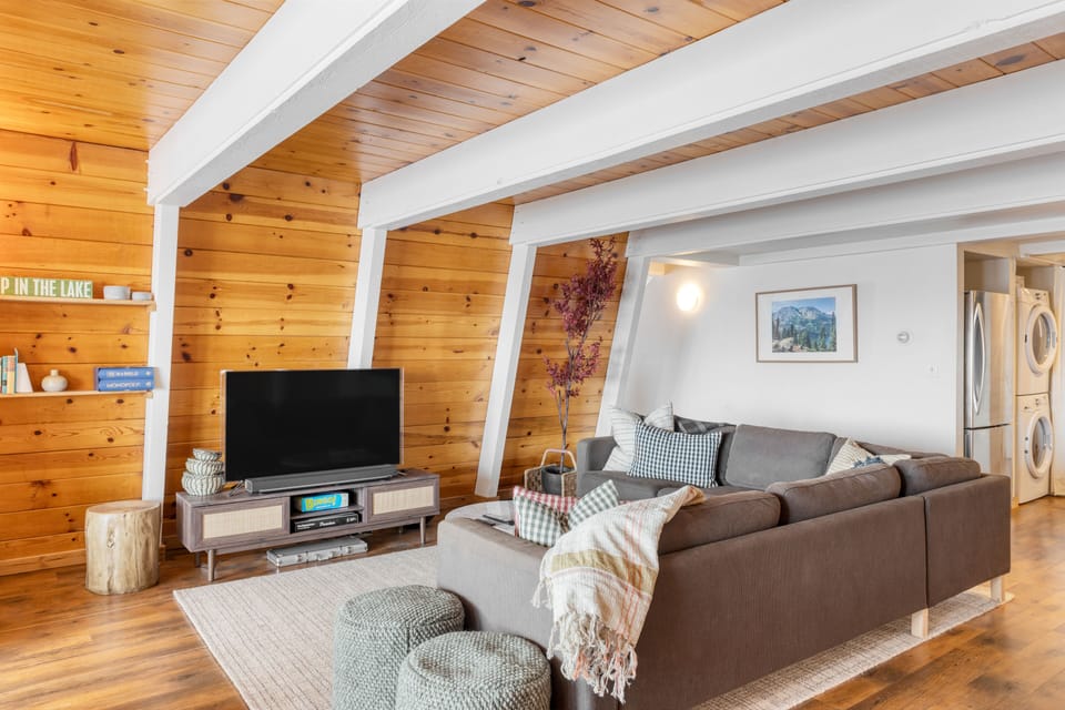 Living room features a large sectional and a TV.