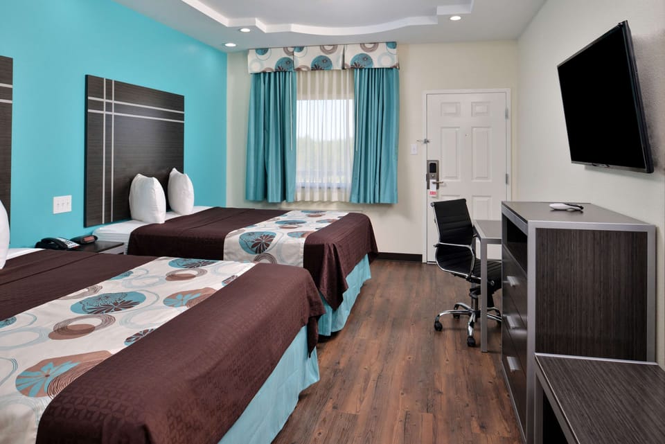 Unwind in a spacious room with comfy beds and workspace.
