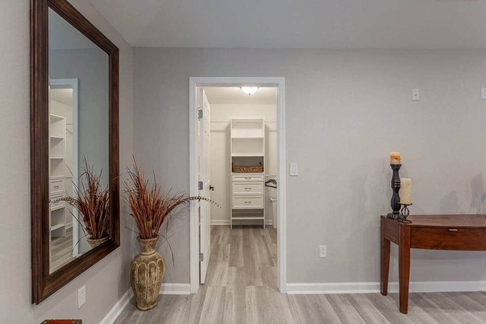 Oversized mirror conveniently located to extra-large closet makes getting ready for the day a breeze.