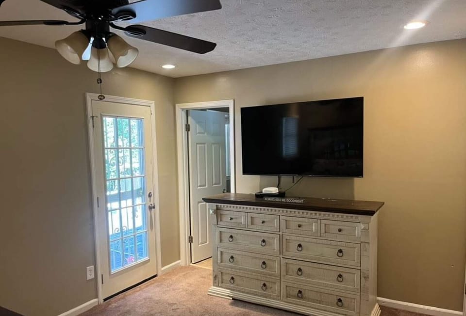 Bedroom 3:   King size bed, dresser, 65" smart TV, door entry to pool deck. 