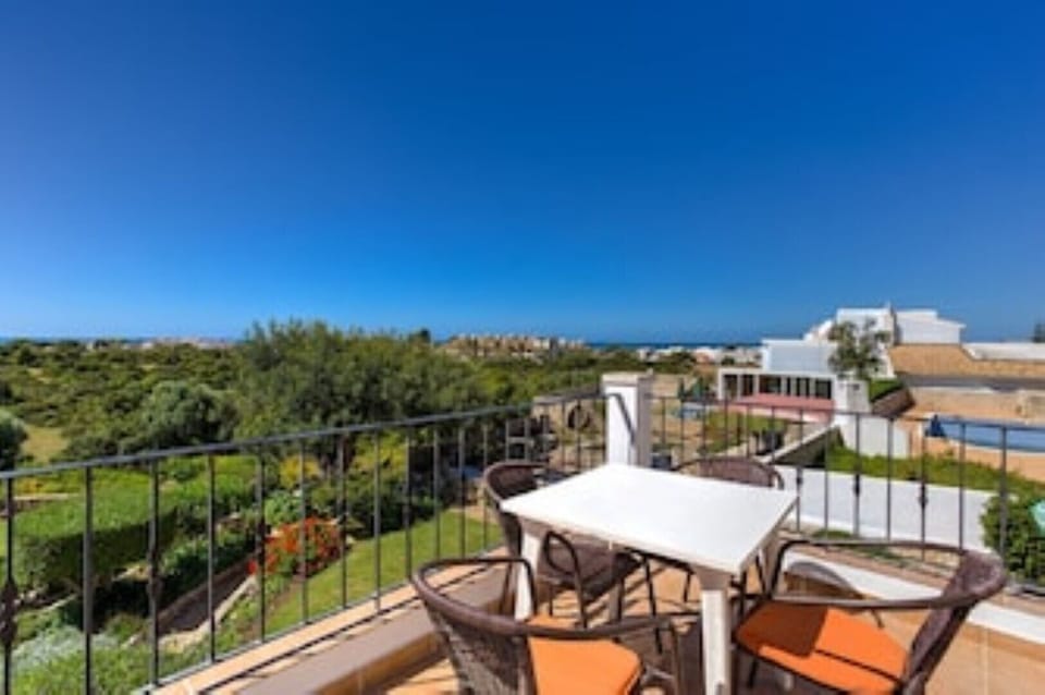 View of the garden and sea from the terrace in Penthouse apartment.