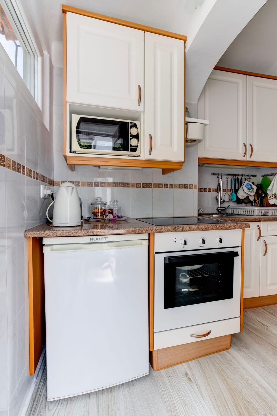 oven, hob, fridge and microwave. 