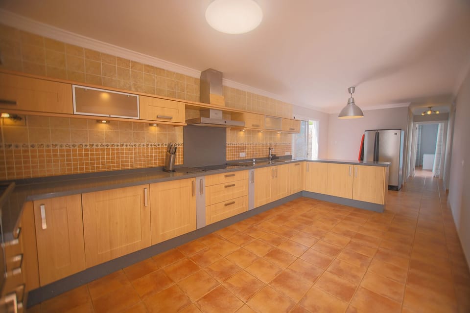 Fully equipped kitchen featuring a breakfast bar and family dining space