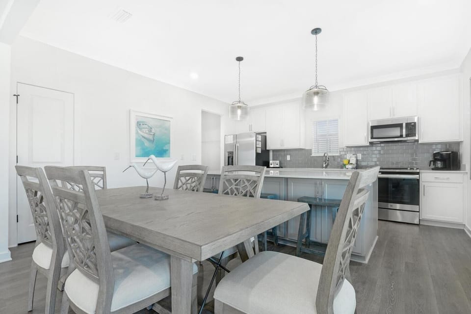 The kitchen and dining area seamlessly integrate to form the heart of the home where loved ones gather to share experiences over a comforting home-cooked meal.