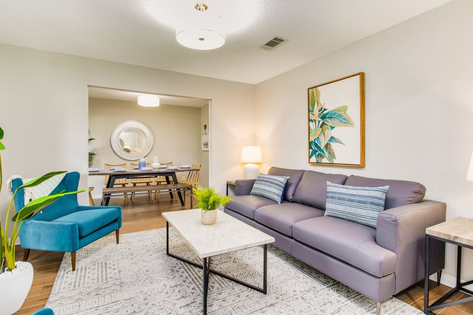 Welcome to the stunning front living room area - with a cozy couch and two armchairs.