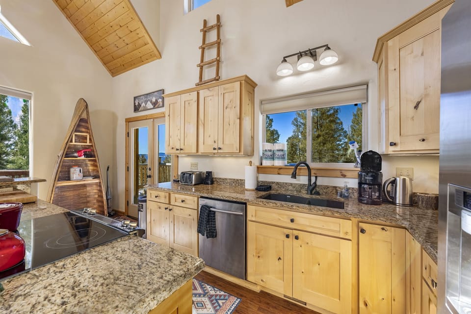 The fully stocked kitchen with all stainless appliances