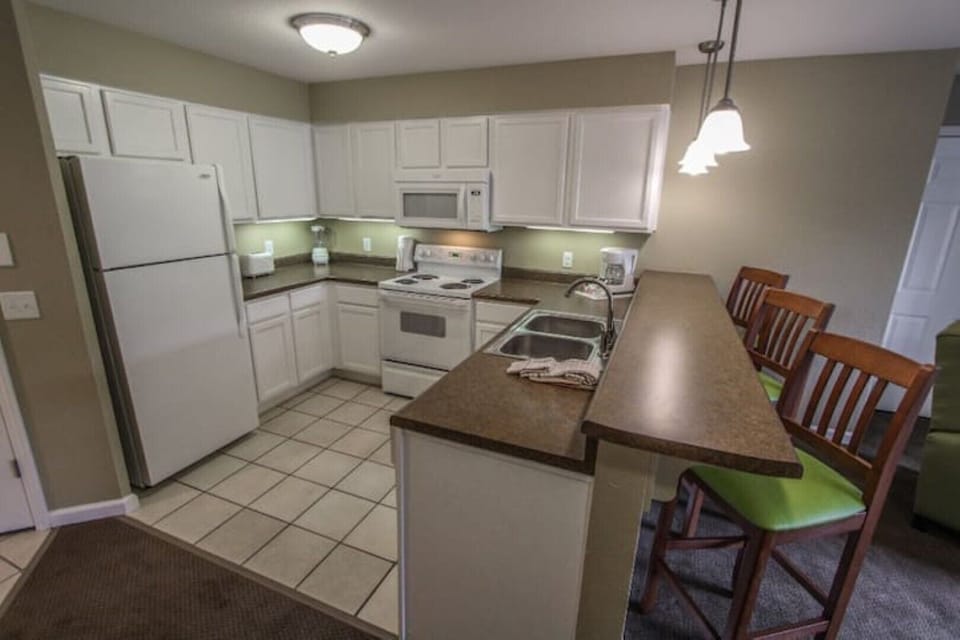 The modern kitchen comes fully equipped and stocked with cookware and utensils
