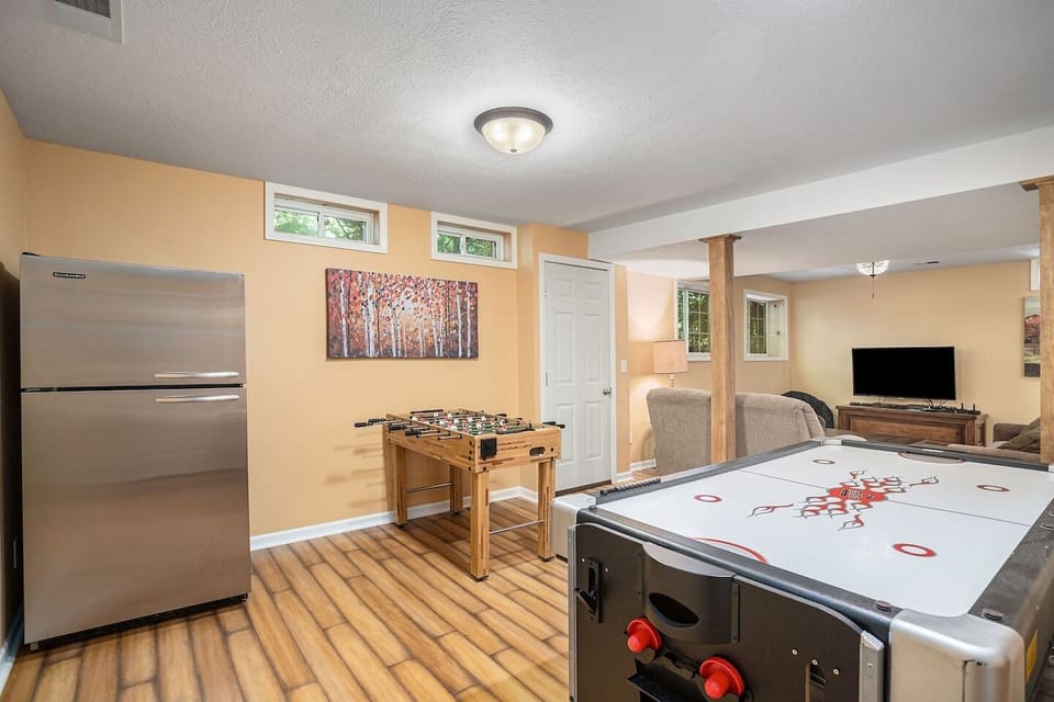 You’ll find in the game room a ping-pong table, dartboard, foosball, air hockey, TV, and a large fridge, along with plush seating.