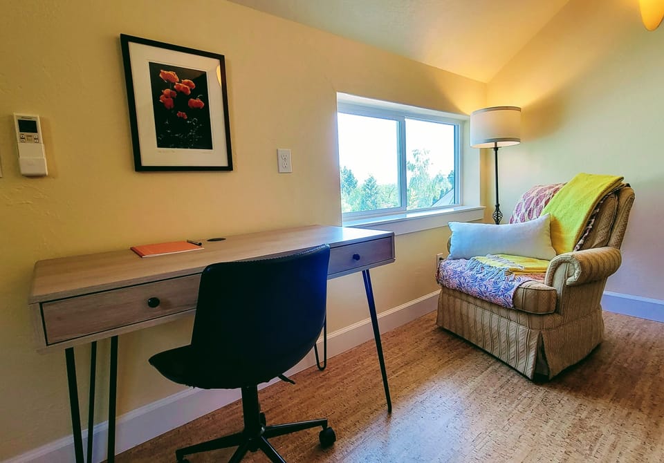 A sweet book nook and tidy desk area for a home office. 
