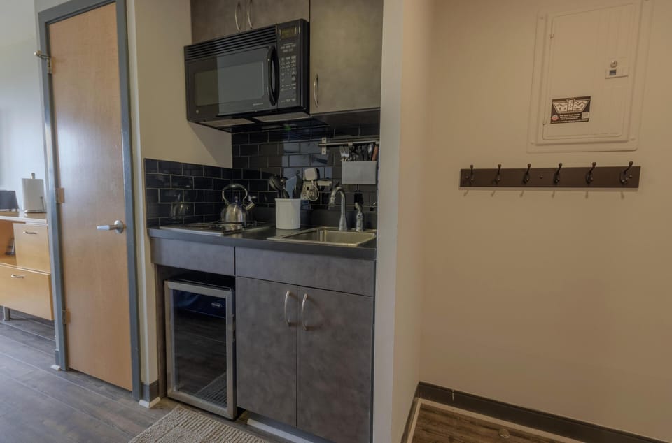 The kitchenette comes with a microwave, fridge (please note this is a mini fridge), a two-burner range, and has all the basics you'll need to prepare, cook, and serve a delicious meal.