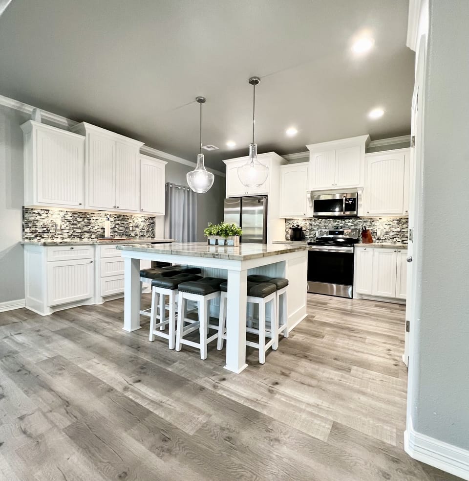 Kitchen space with 8 stools and a large island.