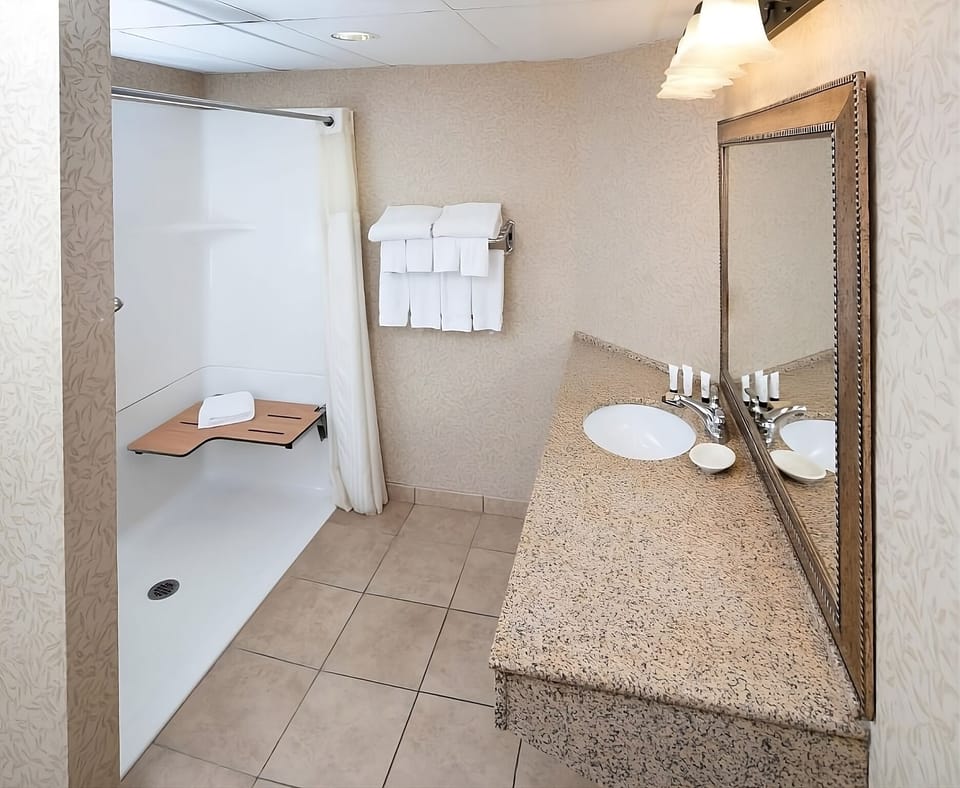 Get ready comfortably with a wide vanity and bright lighting.