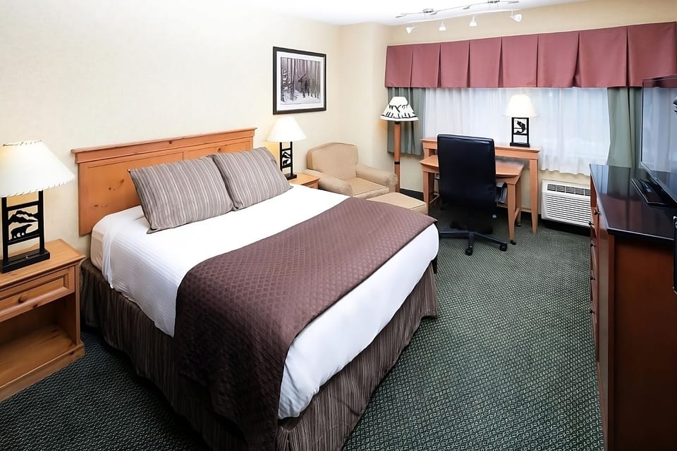Recharge in a calm king room with dedicated workspace.