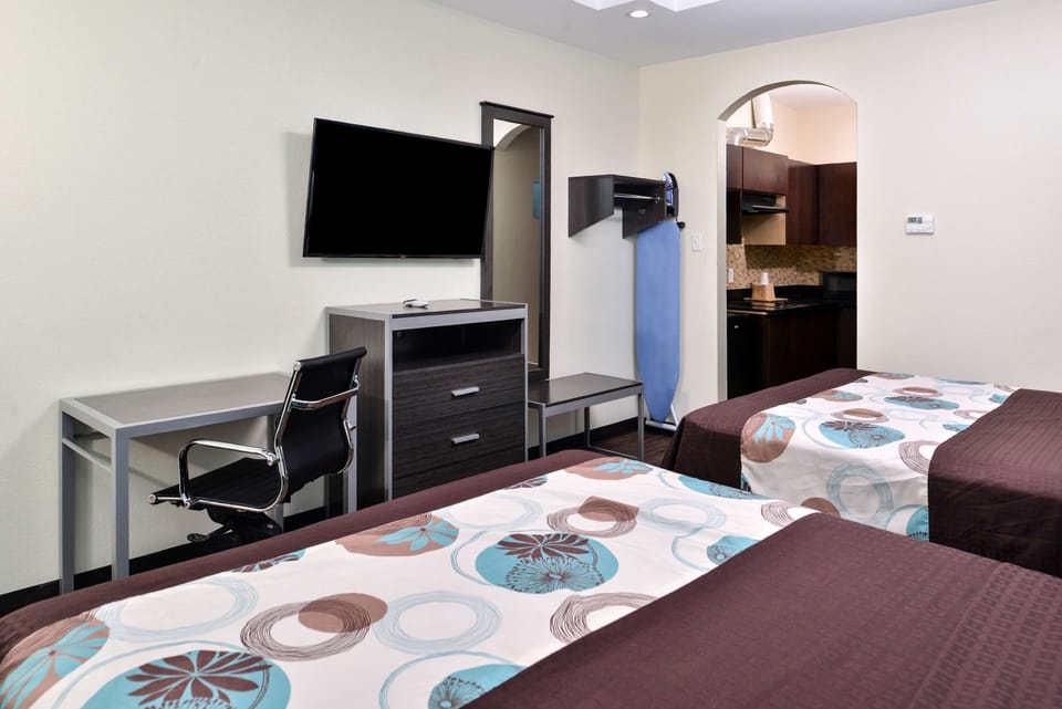 Unwind on plush beds with TV and easy workspace.