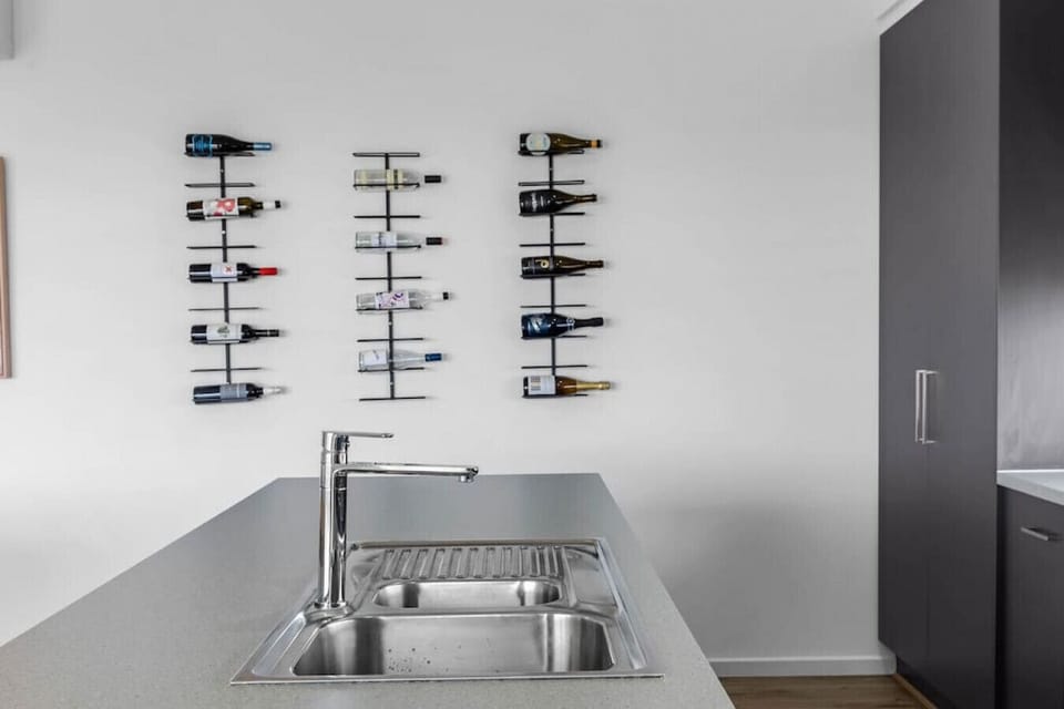 `The kitchen`s faucet area is a hub of functionality, featuring a sleek and modern design that makes meal prep and cleanup a breeze.
