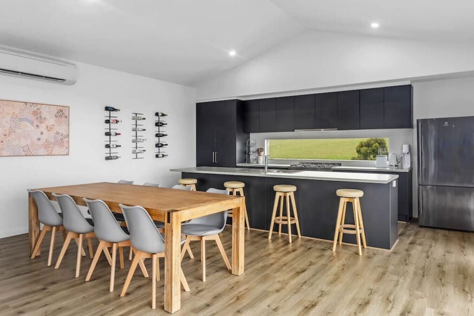 The kitchen seamlessly flows into the dining area, creating a warm and inviting space perfect for meal preparation and sharing delicious moments with loved ones.