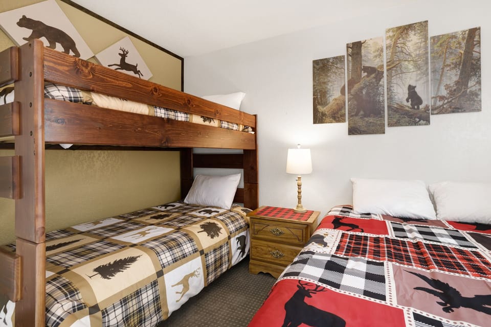 Peaceful cabin bedroom with plush bedding, and beautiful views—ideal for restful nights, cozy mornings, and a relaxing mountain escape.