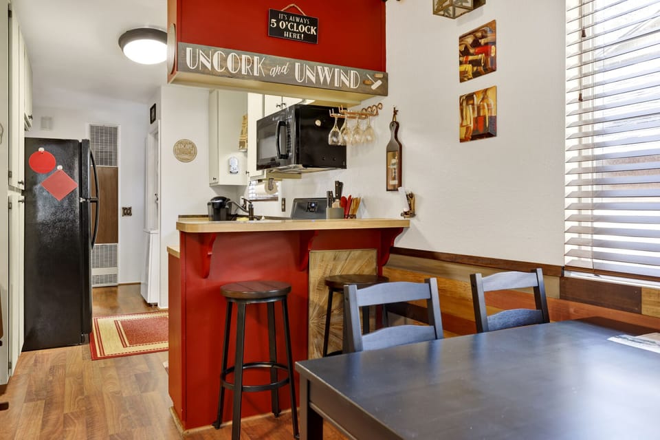 Fully equipped cabin kitchen with ample cabinetry, stove, fridge, microwave, and coffee maker—perfect for cooking meals, morning coffee, and feeling right at home on your stay.