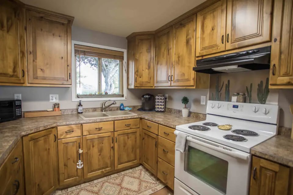 Kitchen fully stocked with seasons and cooking utensils.