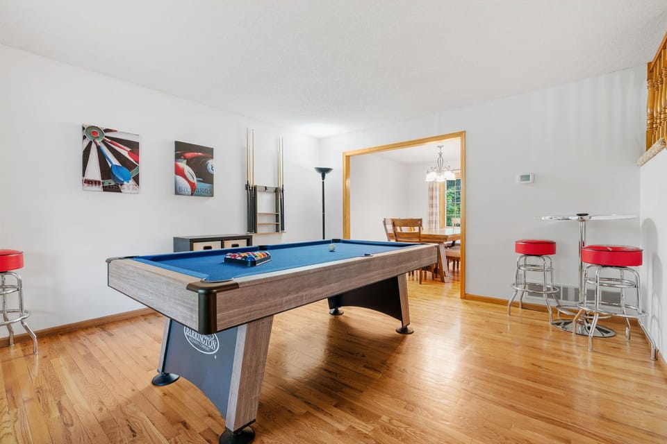 Challenge friends to pool games in your private entertainment space with bar seating and polished hardwood floors.