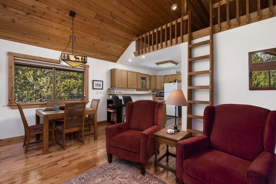 Living room with dining area. Loft is not for guest use.