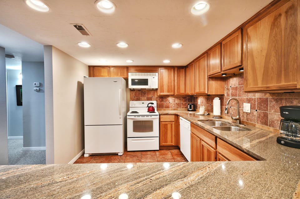 - Fully equipped kitchen with modern appliances throughout  
- Granite countertops and tiled backsplash for style  
- Everything you need for easy vacation cooking