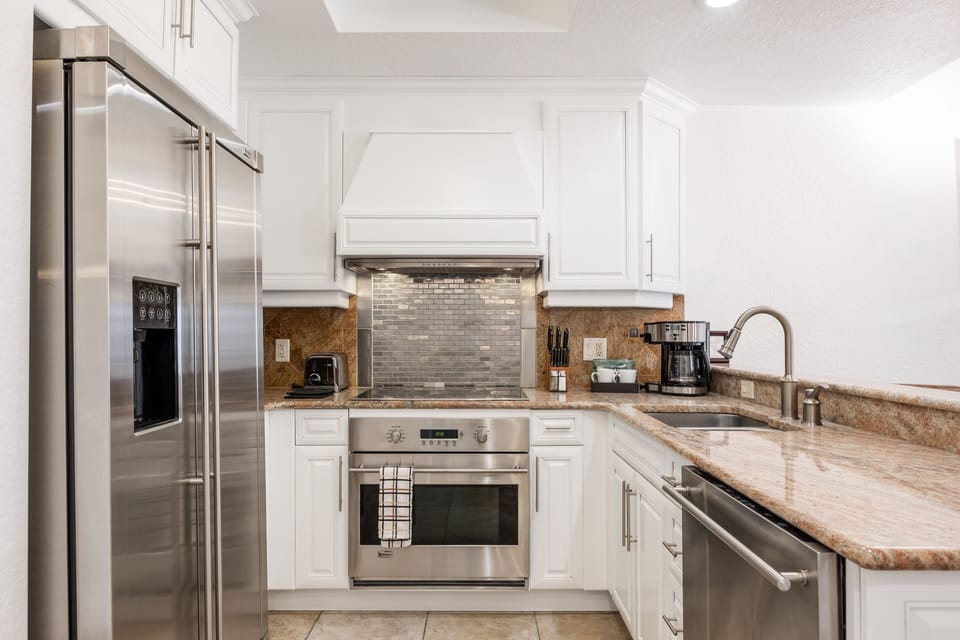 Cook your favorite meals in a modern kitchen featuring stainless steel appliances, granite countertops, and everything you need for a comfortable stay in Canyons Village.