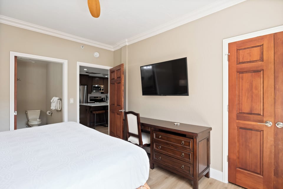 - Bedroom includes flat-screen TV and desk area  
- Ensuite bath access for comfort and privacy  
- Spacious retreat with classic wood accents