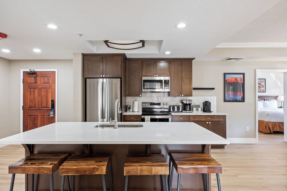 - Spacious kitchen with stainless steel appliances  
- Large island with bar stools for casual dining  
- Fully equipped for cooking during your stay