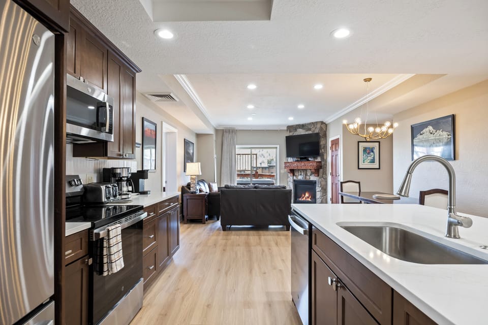 - Open kitchen with modern appliances and seating  
- Spacious design connects to cozy living room  
- Perfect for meals, gatherings, and entertaining
