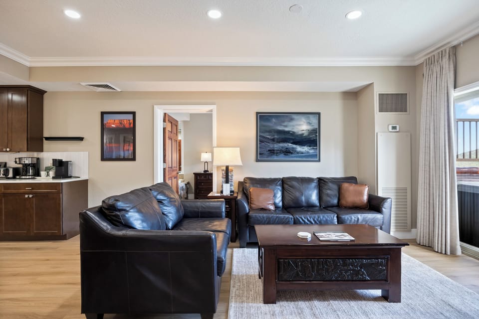 - Comfortable seating area with mountain decor  
- Large windows bring in natural light indoors  
- Relax after skiing in cozy living space