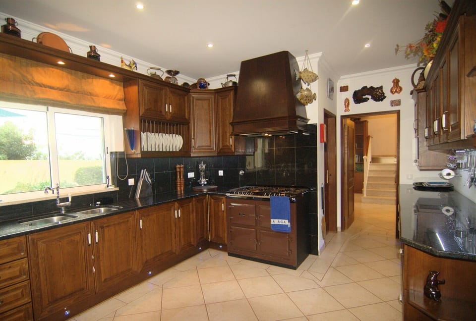 Kitchen with 6 burner gas AGA stove.