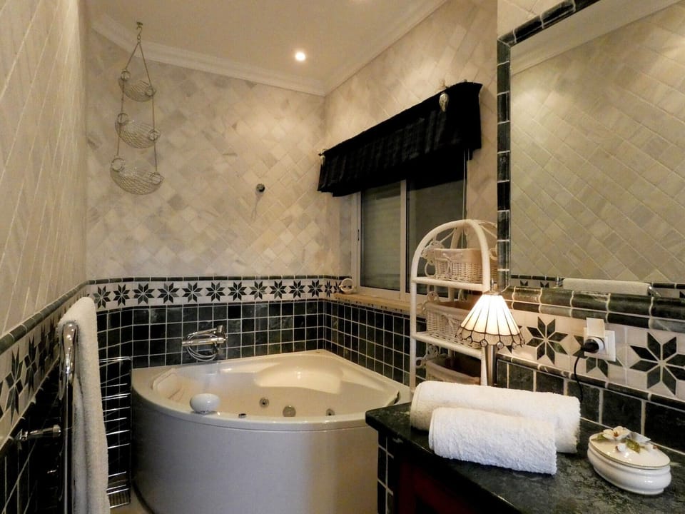 Master bathroom with large corner spa bath and shower.