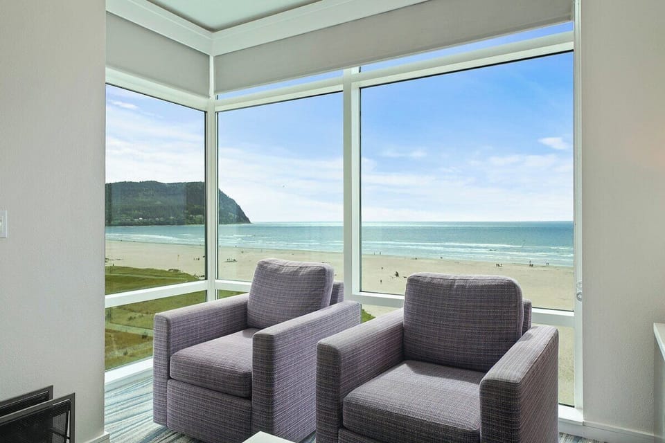 Two swivel chairs overlook the beach from the living room