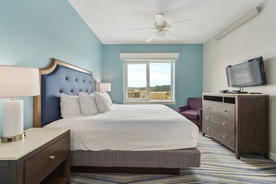 Third bedroom includes a king bed, chair, dresser, and flat panel TV with cable TV