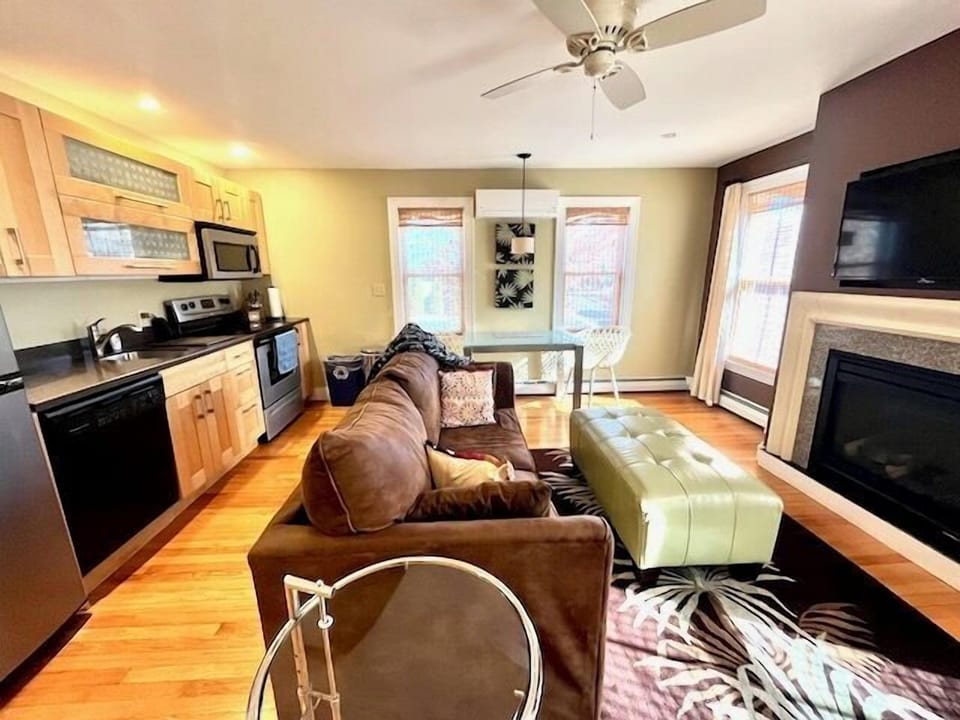 Living room with dining area, fireplace, and full kitchen (2)