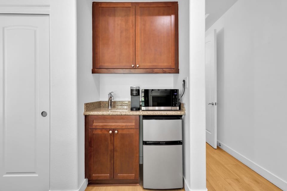 Bedroom two kitchenette with mini-fridge, microwave, sink, and coffee station.