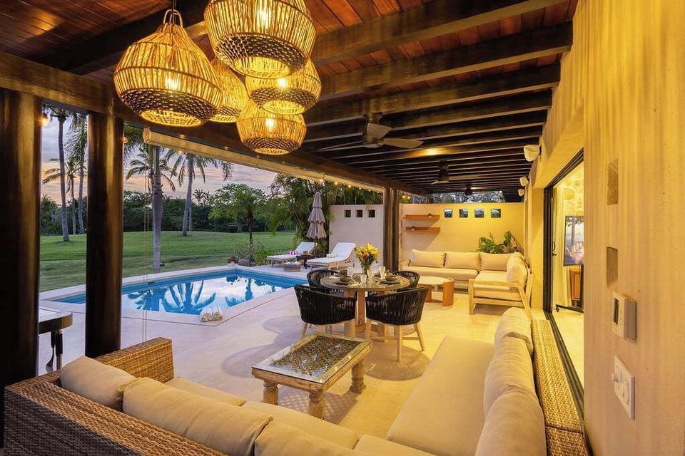 Outdoor living area surrounded by palm trees