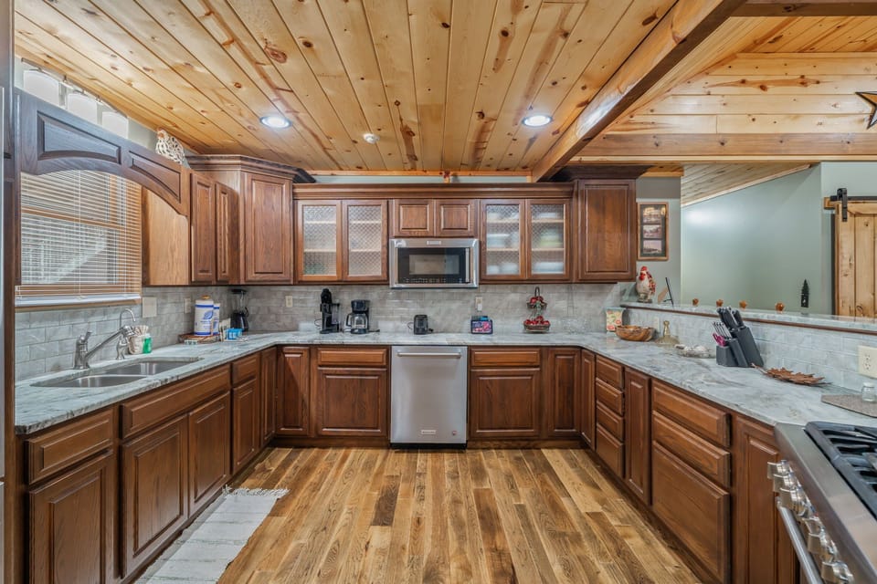 Your spacious kitchen features beautiful wood cabinetry, granite counters, and all appliances for memorable home-cooked meals together.