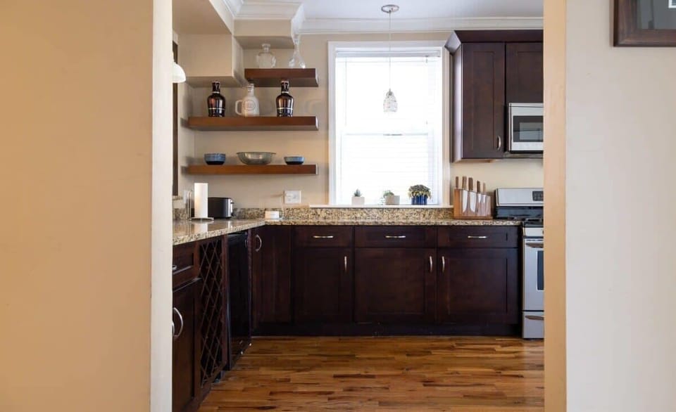 Beautiful custom kitchen with floating shelves, lots of storage, and counter space and fully stocked, ready to cook your next meal