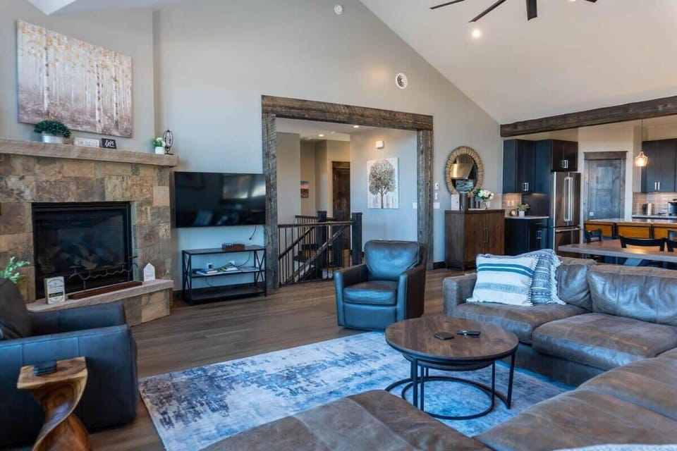 The upper level is a beautiful space with an open-concept living/dining/kitchen area with pitched ceilings and large windows.