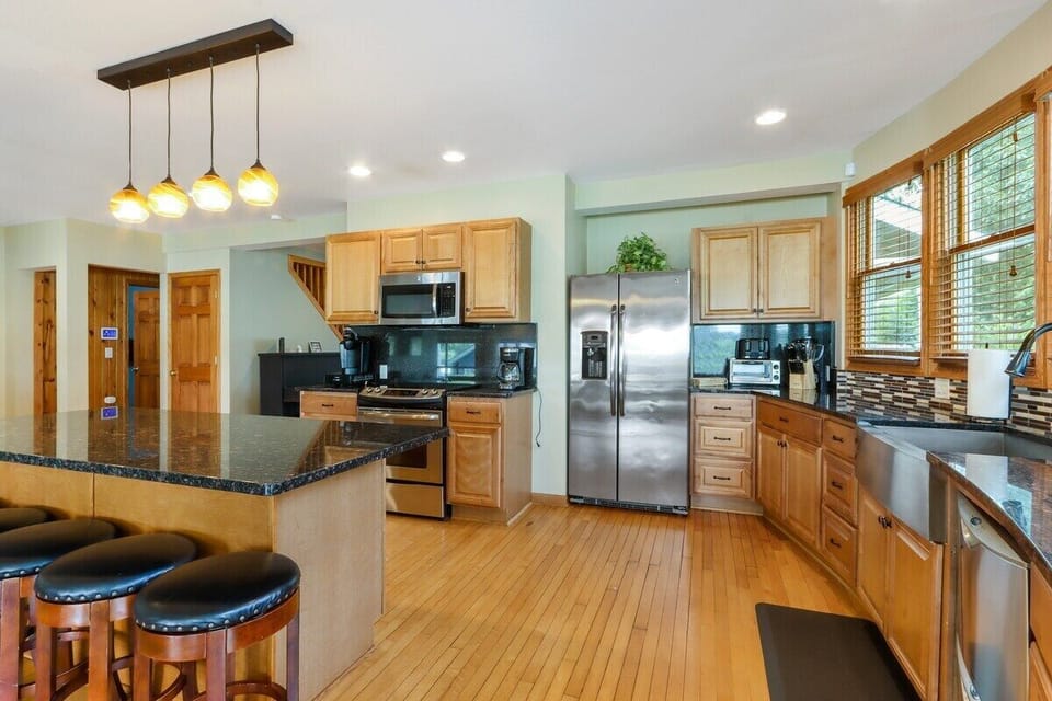 Large refrigerator, dishwasher, electric stove, and microwave.