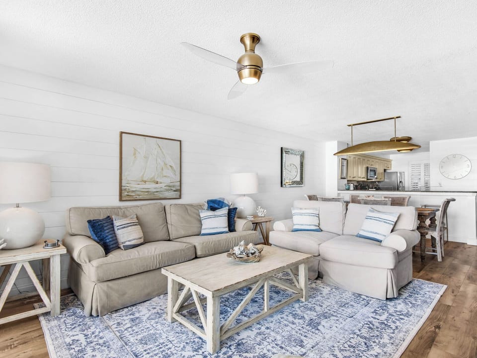 Sink into the plush sectional and let coastal charm embrace you in this bright living space with nautical art and ocean-blue accents.