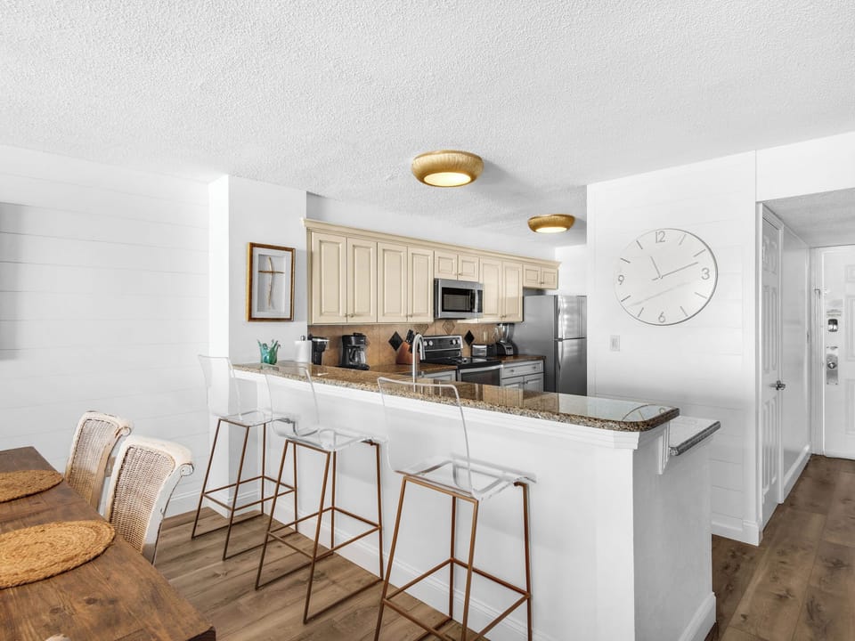 Your modern kitchen features granite counters, stainless appliances, and a breakfast bar perfect for morning coffee or casual dining.