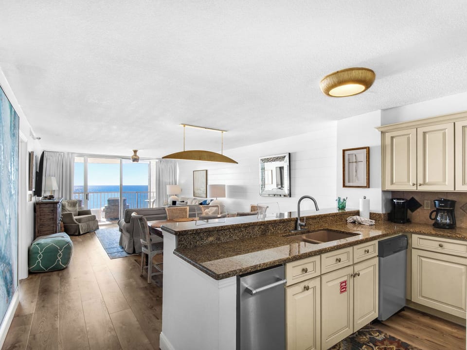 Your open-concept kitchen flows seamlessly into the living space, where granite counters and ocean views create the perfect setting for cooking.