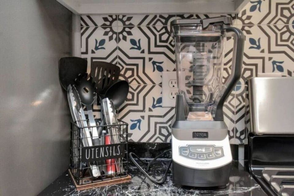 High-powered Ninja blender and full utensil set—perfect for smoothies, sauces, or cocktails.