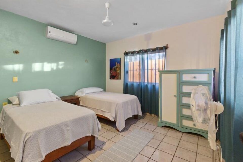 The 2nd bedroom has two full-size beds and a dresser.