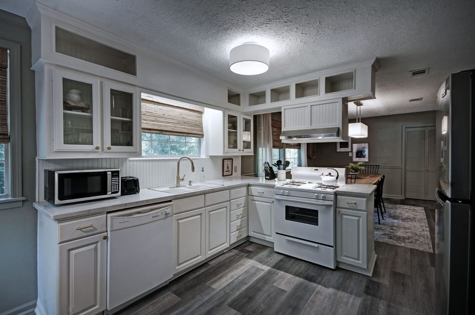 The renovated kitchen with a stove, oven, dishwasher, microwave, refrigerator, kettle, and a Keurig with pods.  Perfect for a corporate stay.